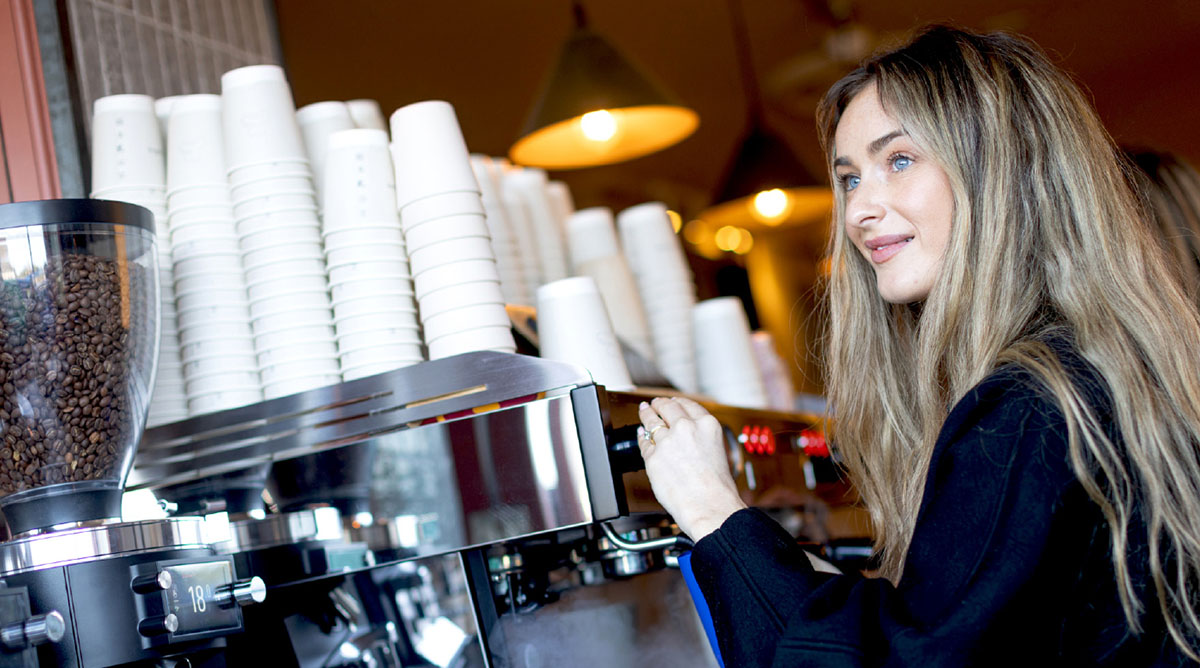 Cafe scene - barista operating coffee machine 