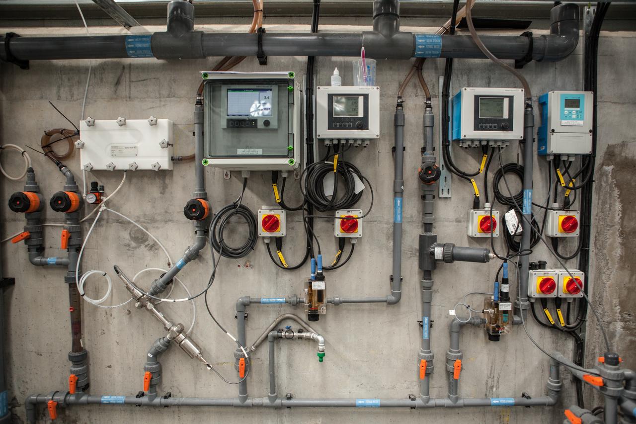 Control room with wires, pipes and monitors