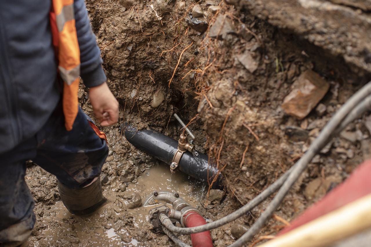 An engineer fixing a leak