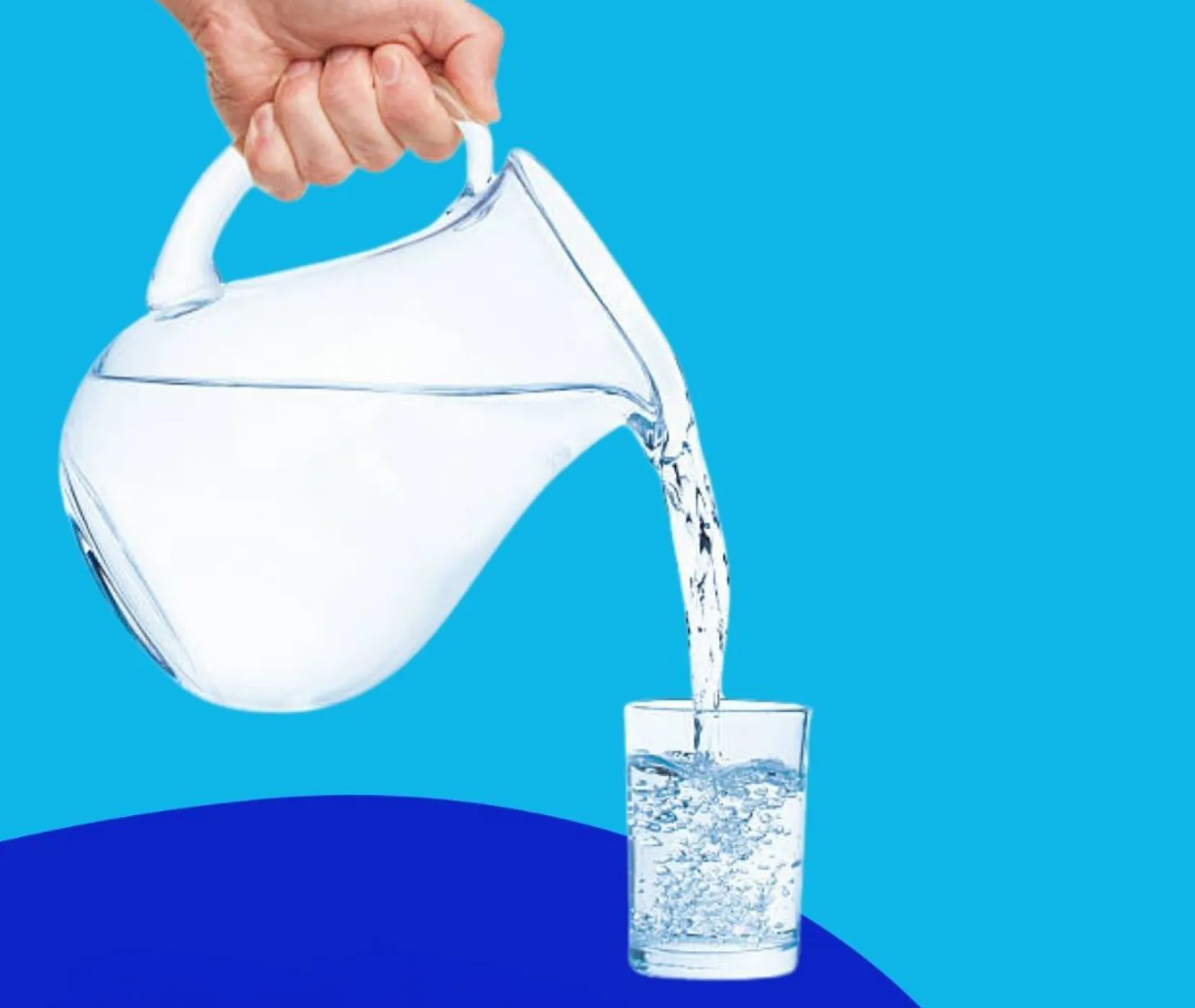 Water being poured from a jug into the glass