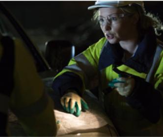 An engineer pointing at a map at night
