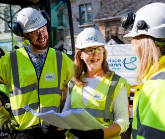 A group of Uisce Éireann workers discussing work plans 