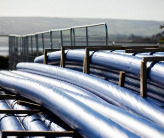 Several plastic blue pipes stacked up